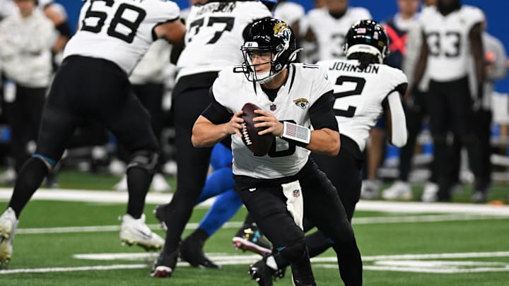 Nov 17, 2024; Detroit, Michigan, USA; Jacksonville Jaguars quarterback Mac Jones (10) rolls out of the pocket against the Detroit Lions in the first quarter at Ford Field. Mandatory Credit: Lon Horwedel-Imagn Images