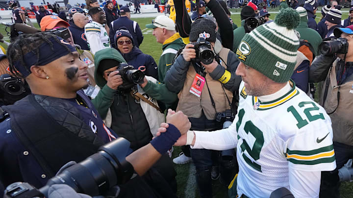 Dec 4, 2022; Chicago, Illinois, USA; Chicago Bears quarterback Justin Fields (1) and Green Bay Packers quarterback Aaron Rodgers (12) meet after their game at Soldier Field. Mandatory Credit: Mark Hoffman-Imagn Images
