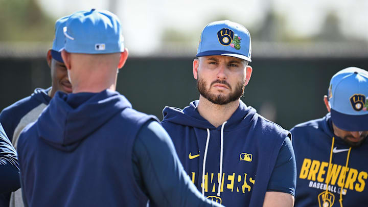Milwaukee Brewers pitcher Peter Strzelecki listens to instruction from third base coach Matt Erickson before pitchers fielding drills during spring training workouts Sunday, February 15, 2026, at American Family Fields of Phoenix in Phoenix, Arizona.