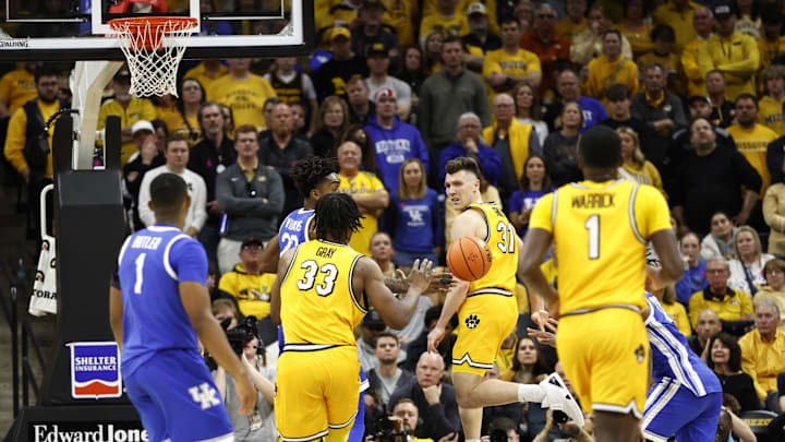Mar 8, 2025; Columbia, Missouri, USA; Missouri Tigers guard Caleb Grill (31) passes the ball behind his back to Missouri Tigers center Josh Gray (33)  in the second half at Mizzou Arena. Mandatory Credit: Gary Rohman-Imagn Images