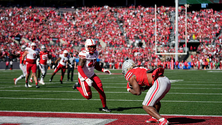Ohio State Buckeyes running back Quinshon Judkins (1) scores makes a touchdown catch against Nebraska Cornhuskers linebacker Mikai Gbayor (42) during the fourth quarter of their game at Ohio Stadium on Oct 26, 2024, in Columbus.