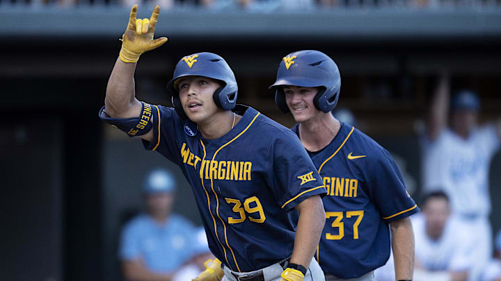 Jun 7, 2024; Chapel Hill, NC, USA; West Virginia Mountaineers Kyle West (39) motions to the dugout in front of teammate Grant Siegel (37) in the fifth inning of the DI Baseball Super Regional against the North Carolina Tar Heels at Boshamer Stadium.  Mandatory Credit: Jeffrey Camarati-Imagn Images
