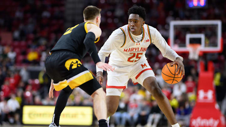 Feb 16, 2025; College Park, Maryland, USA; Maryland Terrapins center Derik Queen (25) handles the ball against Iowa Hawkeyes guard Brock Harding (2) during the second half at Xfinity Center. Mandatory Credit: Reggie Hildred-Imagn Images