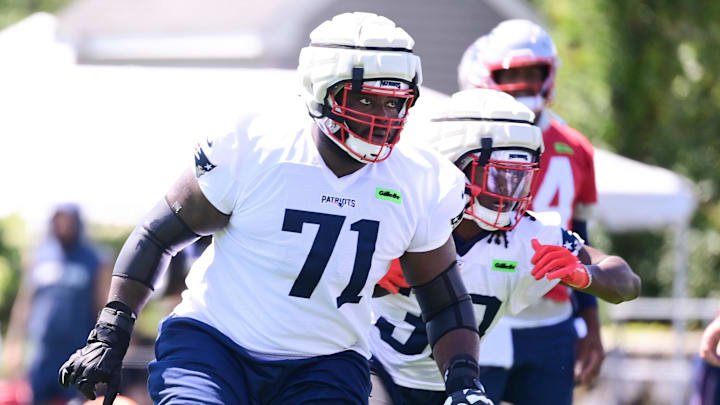 Jul 26, 2024; Foxborough, MA, USA; New England Patriots offensive tackle Mike Onwenu (71) participates in a drill during training camp at Gillette Stadium. Mandatory Credit: Eric Canha-Imagn Images