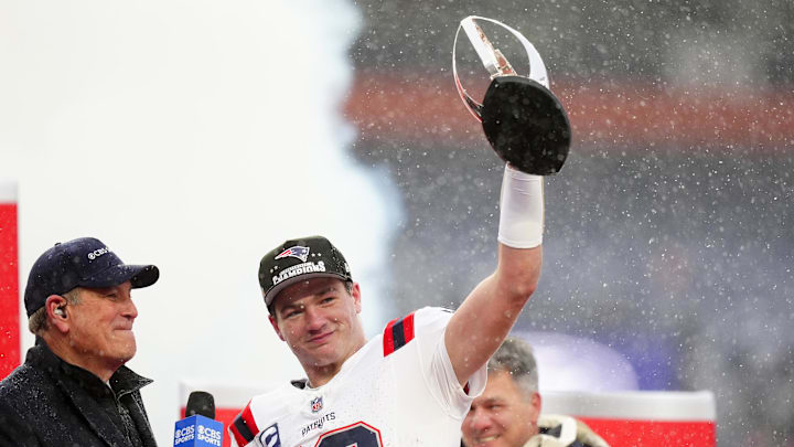 Jan 25, 2026; Denver, CO, USA; New England Patriots quarterback Drake Maye (10) holds the AFC Championship trophy while speaking to the media after defeating the Denver Broncos in the 2026 AFC Championship Game at Empower Field at Mile High. Mandatory Credit: Ron Chenoy-Imagn Images