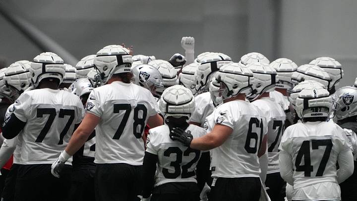 Jul 31, 2023; Henderson, NV, USA; Las Vegas Raiders wearing Guardian helmet caps huddle during training camp at the Intermountain Health Performance Center. Mandatory Credit: Kirby Lee-USA TODAY Sports