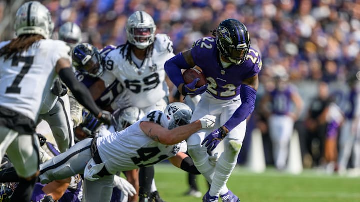 Sep 15, 2024; Baltimore, Maryland, USA; Baltimore Ravens running back Derrick Henry (22) runs the ball while being tackled by Las Vegas Raiders linebacker Robert Spillane (41) during the second half at M&T Bank Stadium. Mandatory Credit: Reggie Hildred-Imagn Images