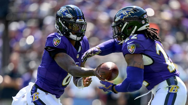 Sep 15, 2024; Baltimore, Maryland, USA; Baltimore Ravens quarterback Lamar Jackson (8) hands off to running back Derrick Henry (22) during the first half against the Las Vegas Raiders at M&T Bank Stadium.