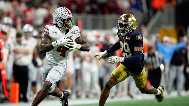 Ohio State Buckeyes wide receiver Jeremiah Smith makes a catch against Notre Dame Fighting Irish cornerback Christian Gray during the College Football Playoff National Championship.
