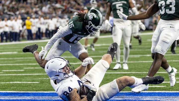 Nov 24, 2023; Detroit, Michigan, USA; Penn State Nittany Lions tight end Theo Johnson (84) scores a touchdown against the Michigan State Spartans during the second half at Ford Field. Mandatory Credit: David Reginek-Imagn Images