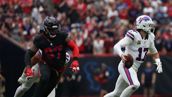 Oct 6, 2024; Houston, Texas, USA;  Buffalo Bills quarterback Josh Allen (17) scrambles from Houston Texans defensive tackle Mario Edwards Jr. (97) in the second half at NRG Stadium. Mandatory Credit: Thomas Shea-Imagn Images