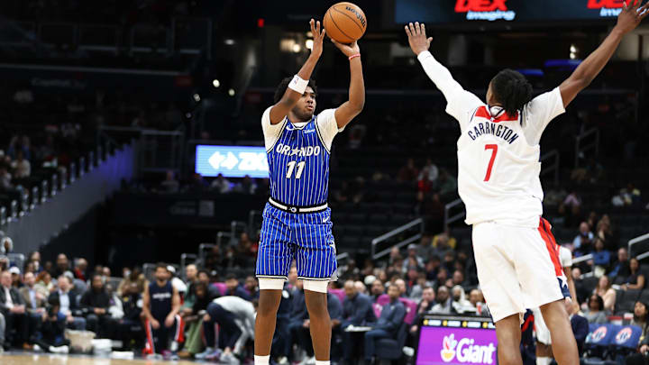 Jan 6, 2026; Washington, District of Columbia, USA; Orlando Magic guard Jase Richardson (11) takes a shot over Washington Wizards guard Bub Carrington (7) during the first half at Capital One Arena. Mandatory Credit: Daniel Kucin Jr.-Imagn Images