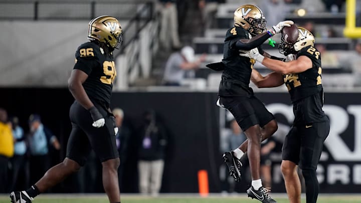 Vanderbilt cornerback Martel Hight (4) celebrates intercepting a Kentucky ball with linebacker Nick Rinaldi (24) during the fourth quarter at FirstBank Stadium in Nashville, Tenn., Saturday, Nov. 22, 2025.