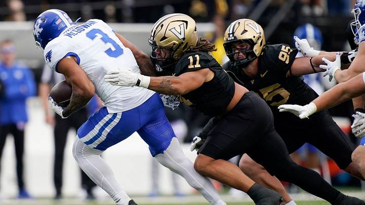Vanderbilt linebacker Bryan Longwell (11) stops Kentucky running back Seth McGowan (3) during the second quarter at FirstBank Stadium in Nashville, Tenn., Saturday, Nov. 22, 2025. Vanderbilt linebacker Bryan Longwell (11) stops Kentucky running back Seth McGowan (3) during the second quarter at FirstBank Stadium in Nashville, Tenn., Saturday, Nov. 22, 2025.