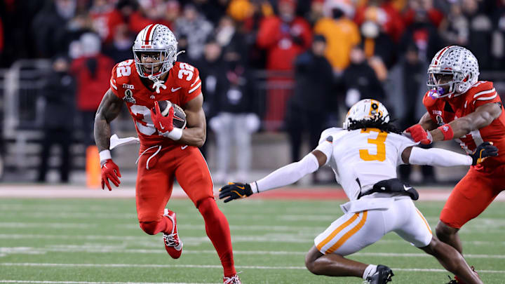 Dec 21, 2024; Columbus, Ohio, USA;  Ohio State Buckeyes running back TreVeyon Henderson (32) runs the ball as Tennessee Volunteers defensive back Jermod McCoy (3) defends during the first quarter at Ohio Stadium. Mandatory Credit: Joseph Maiorana-Imagn Images