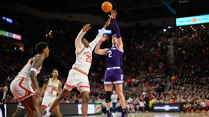 Mar 8, 2025; College Park, Maryland, USA; Northwestern Wildcats forward Nick Martinelli (2) takes a shot over Maryland Terrapins center Derik Queen (25) during the first half at Xfinity Center. Mandatory Credit: Reggie Hildred-Imagn Images