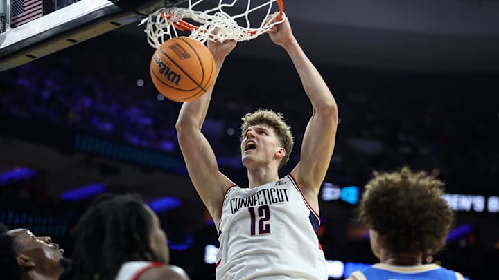 Mar 22, 2026; Philadelphia, PA, USA; UConn Huskies center Eric Reibe (12) dunks the ball against the UCLA Bruins in the first half during a second round game of the men's 2026 NCAA Tournament at Xfinity Mobile Arena. Mandatory Credit: Bill Streicher-Imagn Images