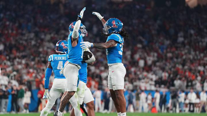 Jan 8, 2026; Glendale, AZ, USA; Mississippi Rebels safety Kapena Gushiken (14) reacts after making an interception against the Miami Hurricanes in the second half during the 2026 Fiesta Bowl and semifinal game of the College Football Playoff at State Farm Stadium. Mandatory Credit: Joe Camporeale-Imagn Images