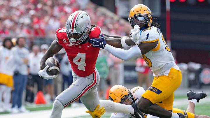 Ohio State Buckeyes wide receiver Jeremiah Smith (4) gets taken down by Kent State Golden Flashes safety Clinton Robinson (38) and defensive back A'tiq Muhammad (1) after a catch in the first quarter of the NCAA football game at Ohio Stadium on Sept. 19, 2026. Ohio State Buckeyes wide receiver Jeremiah Smith (4) gets taken down by Kent State Golden Flashes safety Clinton Robinson (38) and defensive back A'tiq Muhammad (1) after a catch in the first quarter of the NCAA football game at Ohio Stadium on Sept. 19, 2026.