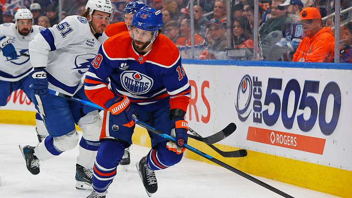 Mar 21, 2026; Edmonton, Alberta, CAN; Edmonton Oilers forward Adam Henrique (19) looks to make a pass in front of Tampa Bay Lightning defensemen Charle-Edouard D'Astous (51) during the first period at Rogers Place. Mandatory Credit: Perry Nelson-Imagn Images Mar 21, 2026; Edmonton, Alberta, CAN; Edmonton Oilers forward Adam Henrique (19) looks to make a pass in front of Tampa Bay Lightning defensemen Charle-Edouard D'Astous (51) during the first period at Rogers Place. Mandatory Credit: Perry Nelson-Imagn Images
