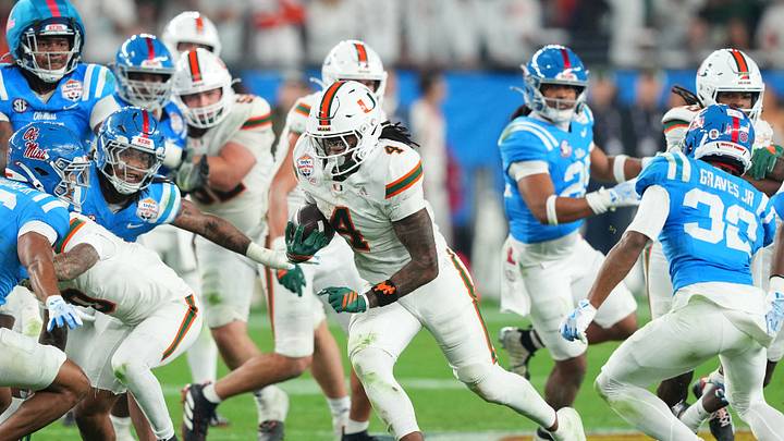 Jan 8, 2026; Glendale, AZ, USA; Miami Hurricanes running back Mark Fletcher Jr. (4) rushes the ball against the Mississippi Rebels in the second half during the 2026 Fiesta Bowl and semifinal game of the College Football Playoff at State Farm Stadium. Mandatory Credit: Joe Camporeale-Imagn Images
