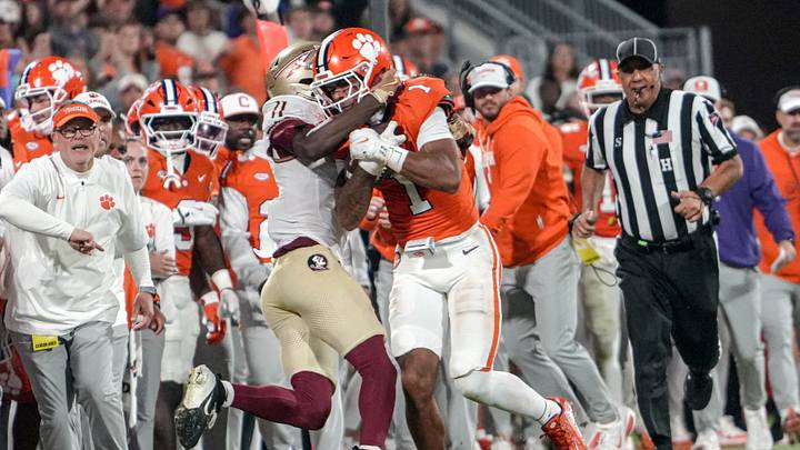 Nov 8, 2025; Clemson, South Carolina, USA; Florida State Seminoles defensive back Ja'Bril Rawls (11) tackles Clemson Tigers wide receiver T.J. Moore (1) during the second quarter at Memorial Stadium. Mandatory Credit: Ken Ruinard - GREENVILLE NEWS-USA TODAY Network via Imagn Images Nov 8, 2025; Clemson, South Carolina, USA; Florida State Seminoles defensive back Ja'Bril Rawls (11) tackles Clemson Tigers wide receiver T.J. Moore (1) during the second quarter at Memorial Stadium. Mandatory Credit: Ken Ruinard - GREENVILLE NEWS-USA TODAY Network via Imagn Images