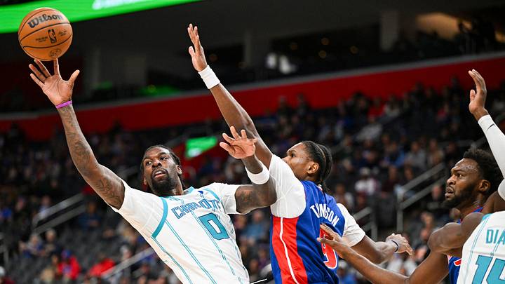 Charlotte Hornets center Naz Reid (0) passes while driving to the basket against Detroit Pistons guard Ausar Thompson Charlotte Hornets center Naz Reid (0) passes while driving to the basket against Detroit Pistons guard Ausar Thompson