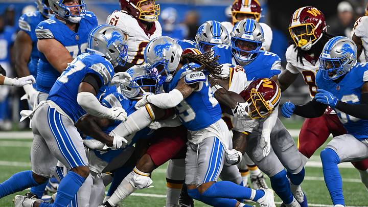 Washington Commanders running back Robert Henry Jr. (30) gets tackled by a host of Detroit Lions tacklers. Washington Commanders running back Robert Henry Jr. (30) gets tackled by a host of Detroit Lions tacklers.
