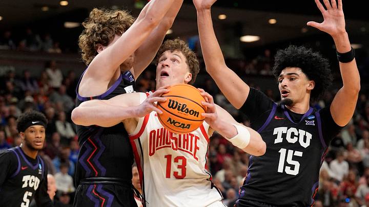 Mar 19, 2026; Greenville, SC, USA; Ohio State Buckeyes Christoph Tilly (13) attempts to shoot the ball over Texas Christian University Horned Frogs David Punch (15) in the first half during a first round game of the men's 2026 NCAA Tournament at Bon Secours Wellness Arena. Mar 19, 2026; Greenville, SC, USA; Ohio State Buckeyes Christoph Tilly (13) attempts to shoot the ball over Texas Christian University Horned Frogs David Punch (15) in the first half during a first round game of the men's 2026 NCAA Tournament at Bon Secours Wellness Arena.