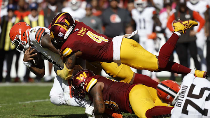 Oct 6, 2024; Landover, Maryland, USA; Washington Commanders linebacker Frankie Luvu (4) and Commanders defensive tackle Jonathan Allen (93) sack Cleveland Browns quarterback Deshaun Watson (4) during the second quarter at NorthWest Stadium. Mandatory Credit: Geoff Burke-Imagn Images