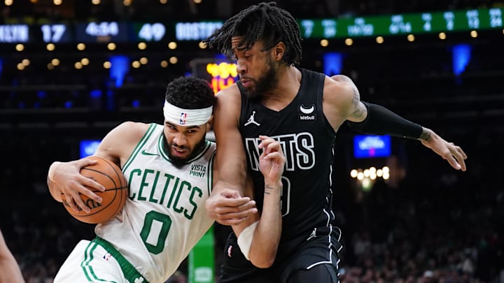Feb 14, 2024; Boston, Massachusetts, USA; Boston Celtics forward Jayson Tatum (0) drives the ball against Brooklyn Nets forward Trendon Watford (9) in the first half at TD Garden. Mandatory Credit: David Butler II-Imagn Images