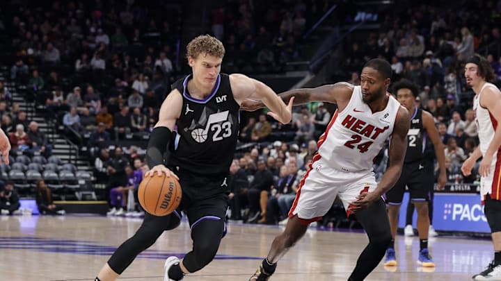 Jan 9, 2025; Salt Lake City, Utah, USA;  Utah Jazz forward Lauri Markkanen (23) dribbles the ball past Miami Heat forward Haywood Highsmith (24) during the second half at Delta Center. Mandatory Credit: Chris Nicoll-Imagn Images