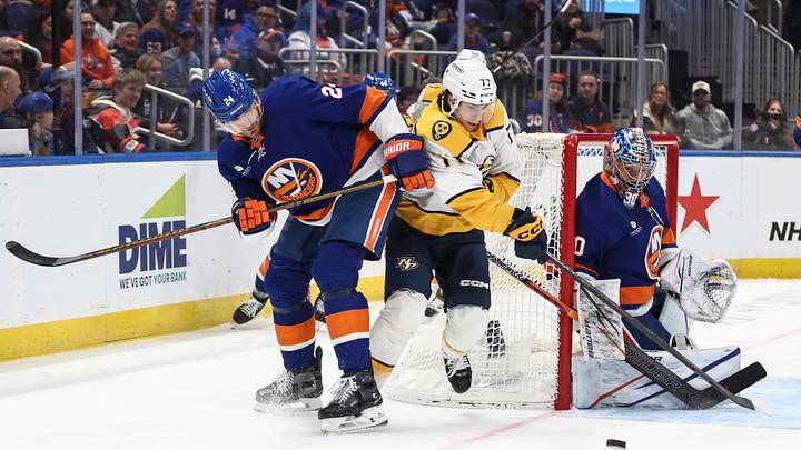 Jan 31, 2026; Elmont, New York, USA; New York Islanders defenseman Scott Mayfield (24) and Nashville Predators right wing Luke Evangelista (77) battle for control of the puck in the first period at UBS Arena. Mandatory Credit: Wendell Cruz-Imagn Images Jan 31, 2026; Elmont, New York, USA; New York Islanders defenseman Scott Mayfield (24) and Nashville Predators right wing Luke Evangelista (77) battle for control of the puck in the first period at UBS Arena. Mandatory Credit: Wendell Cruz-Imagn Images