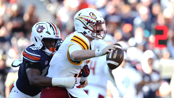 Nov 16, 2024; Auburn, Alabama, USA;  Louisiana Monroe Warhawks quarterback Aidan Armenta (10) is sacked by Auburn Tigers linebacker Demarcus Riddick (16) during the third quarter at Jordan-Hare Stadium. Mandatory Credit: John Reed-Imagn Images