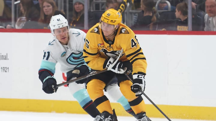 Nov 22, 2025; Pittsburgh, Pennsylvania, USA;  Pittsburgh Penguins center Blake Lizotte (46) moves the puck against pressure from Seattle Kraken defenseman Ryker Evans (41) during the second period at PPG Paints Arena. Mandatory Credit: Charles LeClaire-Imagn Images