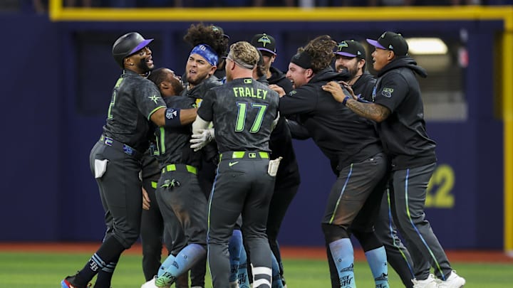 Apr 11, 2026; St. Petersburg, Florida, USA; Tampa Bay Rays first baseman Jonathan Aranda (8) celebrates with center fielder Cedric Mullins (31) and right fielder Jonny DeLuca (21) after beating the New York Yankees in the tenth inning at Tropicana Field. 