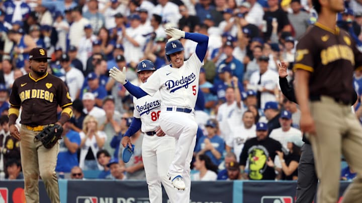 Oct 11, 2024; Los Angeles, California, USA; Los Angeles Dodgers first baseman Freddie Freeman (5) reacts at first base after hitting a single in the first inning against the San Diego Padres during game five of the NLDS for the 2024 MLB Playoffs at Dodger Stadium. Mandatory Credit: Kiyoshi Mio-Imagn Images