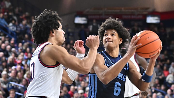 Jan 8, 2025; Spokane, Washington, USA; San Diego Toreros guard Tony Duckett (6) drives against Gonzaga Bulldogs guard Ryan Nembhard (0) in the second half at McCarthey Athletic Center. Gonzaga Bulldogs won 93-80. Mandatory Credit: James Snook-Imagn Images