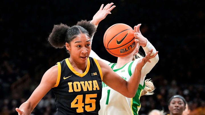 Iowa forward Hannah Stuelke (45) and Oregon forward Mia Jacobs (1) reach for the basketball Jan. 15, 2026 at Carver-Hawkeye Arena in Iowa City, Iowa.