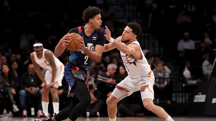 Jan 31, 2024; Brooklyn, New York, USA; Brooklyn Nets forward Cameron Johnson (2) controls the ball against Phoenix Suns guard Devin Booker (1) during the first quarter at Barclays Center. Mandatory Credit: Brad Penner-Imagn Images Jan 31, 2024; Brooklyn, New York, USA; Brooklyn Nets forward Cameron Johnson (2) controls the ball against Phoenix Suns guard Devin Booker (1) during the first quarter at Barclays Center. Mandatory Credit: Brad Penner-Imagn Images
