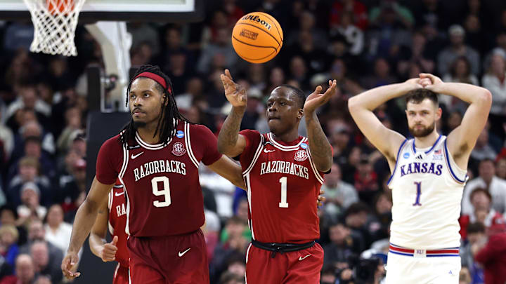 Arkansas Razorback seniors Jonas Aidoo (9) and Johnell Davis (1) head up court during the final seconds of Thursday's first-round win over the Kansas Jayhawks. 