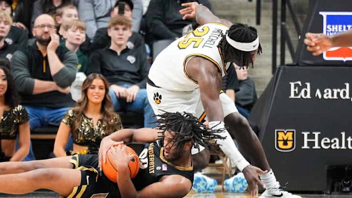 Jan 11, 2025; Columbia, Missouri, USA; Vanderbilt Commodores forward Devin McGlockton (99) and Missouri Tigers guard Mark Mitchell (25) scramble for a loose ball during the second half at Mizzou Arena. Mandatory Credit: Denny Medley-Imagn Images