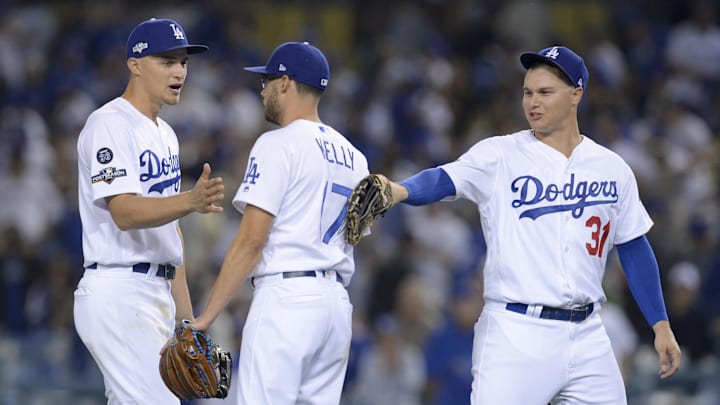 Dodgers shortstop Corey Seager (left) celebrates with relief pitcher Joe Kelly (17) and left fielder Joc Pederson (31) after game one of the 2019 NLDS playoff baseball series against the Washington Nationals at Dodger Stadium on Oct. 3, 2019.