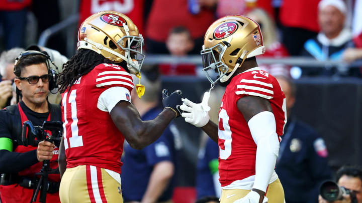 Dec 17, 2023; Glendale, Arizona, USA; San Francisco 49ers wide receiver Deebo Samuel (19) celebrates with wide receiver Brandon Aiyuk (11) after scoring a touchdown during the first quarter against the Arizona Cardinals at State Farm Stadium. Mandatory Credit: Mark J. Rebilas-USA TODAY Sports