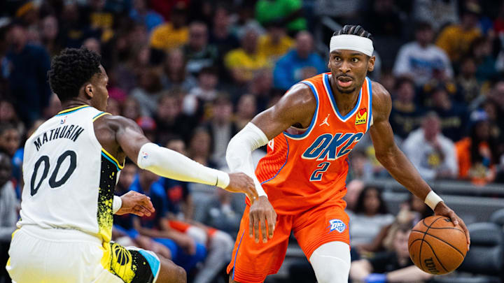 Dec 26, 2024; Indianapolis, Indiana, USA; Oklahoma City Thunder guard Shai Gilgeous-Alexander (2) dribbles the ball while Indiana Pacers guard Bennedict Mathurin (00) defends in the second half at Gainbridge Fieldhouse. Mandatory Credit: Trevor Ruszkowski-Imagn Images