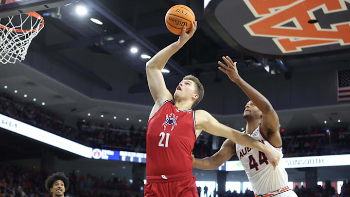 Dec 8, 2024; Auburn, Alabama, USA;  Richmond Spiders center Mike Walz (21) blocks out Auburn Tigers center Dylan Cardwell (44) and grabs a rebound during the second half at Neville Arena. Mandatory Credit: John Reed-Imagn Images