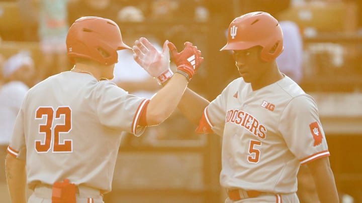 Indiana Hoosiers infielder Josh Pyne (32) celebrates after Indiana Hoosiers infielder Devin Taylor (5) hits a home run during the NCAA baseball game against the Purdue Boilermakers, Friday, May 3, 2024, at Alexander Field in West Lafayette, Ind. Purdue won 7-4.