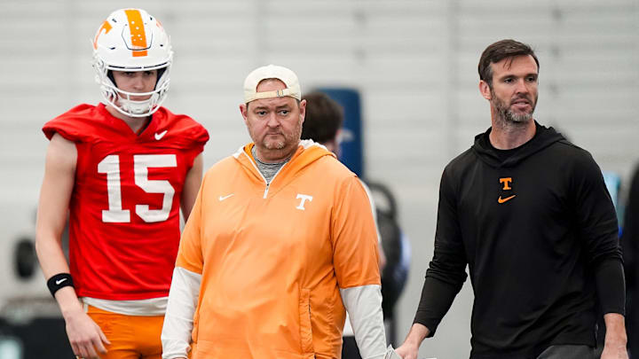 Tennessee coach Josh Heupel with Tennessee quarterback George MacIntyre (15) and offensive coordinator Joey Halzle during the Vols' spring football practice in Knoxville on March 17, 2026. Tennessee coach Josh Heupel with Tennessee quarterback George MacIntyre (15) and offensive coordinator Joey Halzle during the Vols' spring football practice in Knoxville on March 17, 2026.