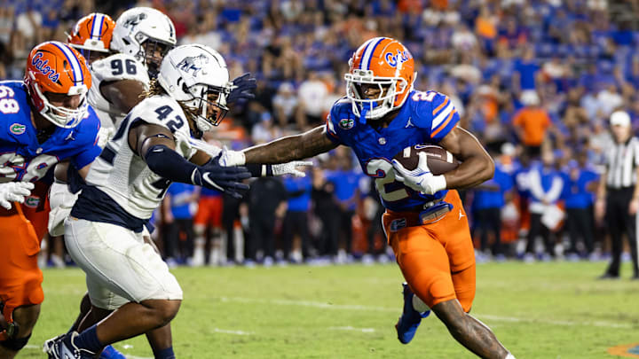 Sep 7, 2024; Gainesville, Florida, USA; Florida Gators running back KD Daniels (21) rushes with the ball past Samford Bulldogs defensive end Jordan Russell (42) during the second half at Ben Hill Griffin Stadium. Mandatory Credit: Matt Pendleton-Imagn Images