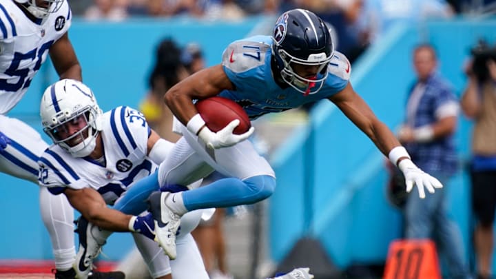 Tennessee Titans wide receiver Chimere Dike (17) is tripped up by Indianapolis Colts safety Daniel Scott (32) during the first quarter at Nissan Stadium in Nashville, Tenn., Sunday, Sept. 21, 2025.